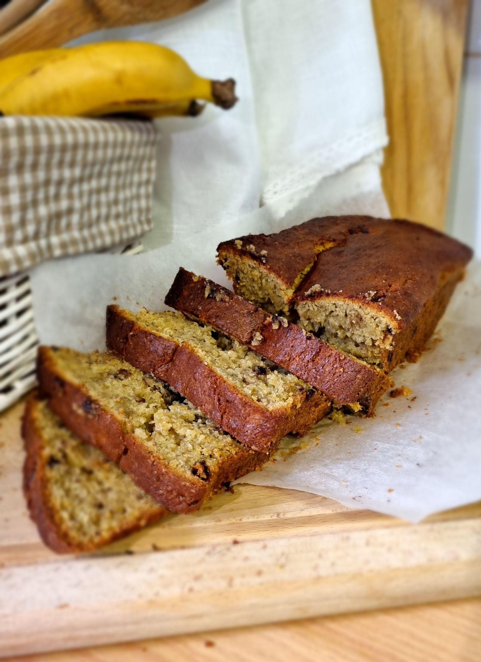 A loaf of classic banana bread on a wooden board